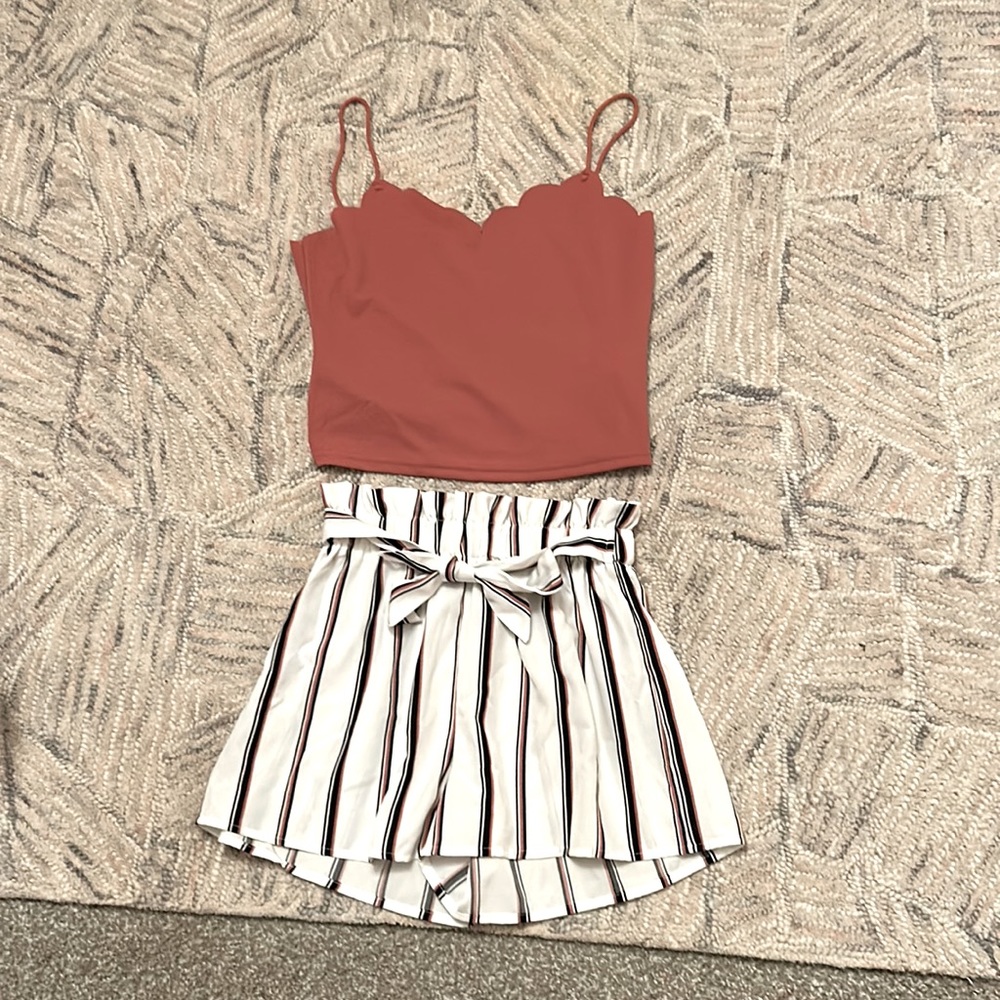 Pink top and striped cream and pink short with bow in front